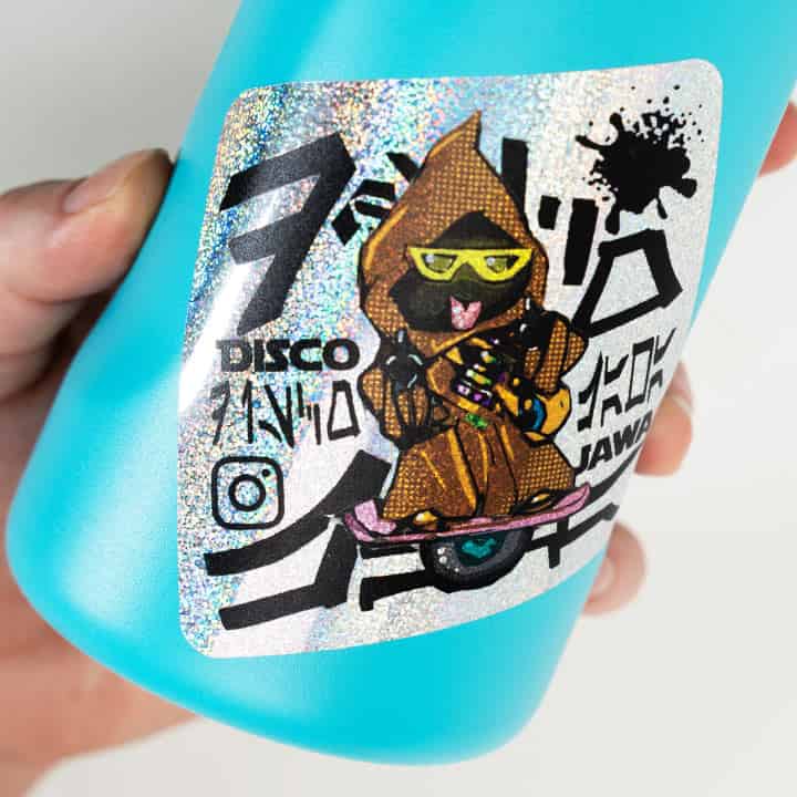 Blue bottle with a glitter sticker featuring a character and text.