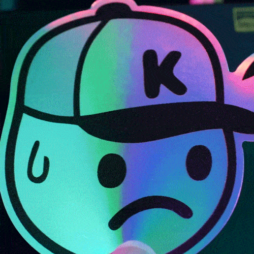 holographic sad face with a ball cap being stuck on a black surface