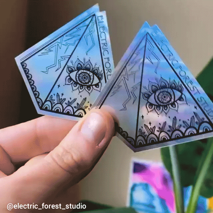 gif of holographic pyramid stickers shining in the sunlight
