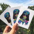 Colorful Darth Vader kiss cut stickers held against a natural background