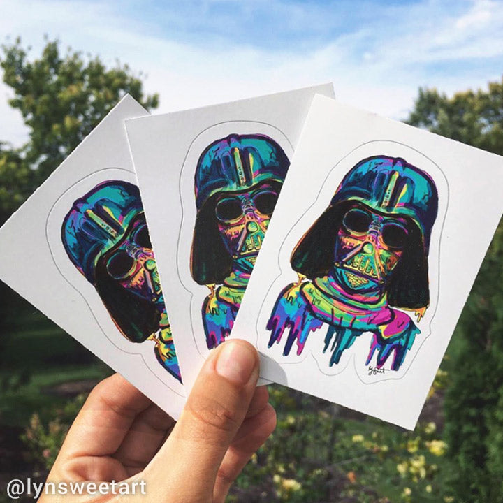 Colorful Darth Vader kiss cut stickers held against a natural background